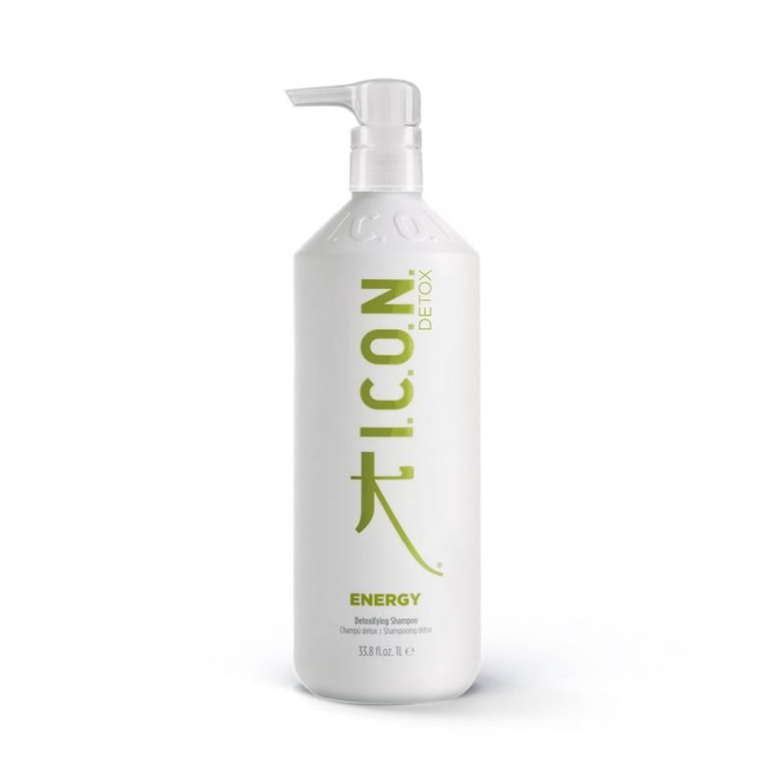 A white bottle of Industry Beauty Supply I.C.O.N. Energy Detoxifying Shampoo with a pump, green text, and 1000mL size, formulated with organic oils to strengthen hair.